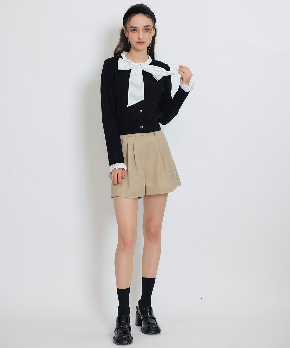 エンブレムボタンケーブルリボンタイニットトップス